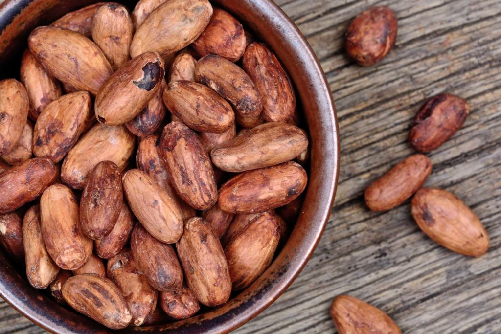 Cacao beans in a bowl on table